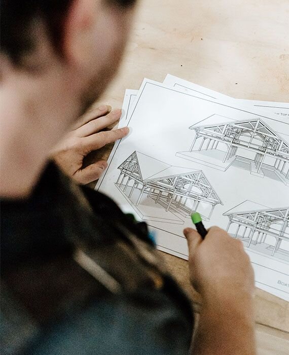 A craftsman looking at a drawing of an outdoor structure